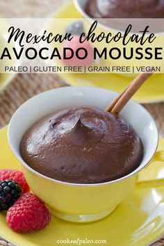 mexican chocolate avocado mousse in a yellow bowl with raspberries on the side