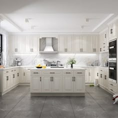 a large kitchen with white cabinets and marble flooring