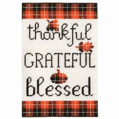 a cross stitch pattern with the words grateful and an apple on it, in black and orange