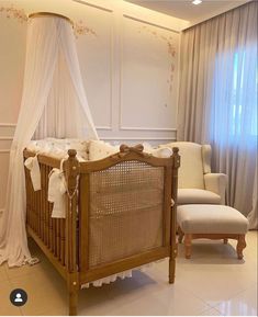 a baby's crib in the corner of a room with drapes and curtains