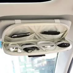 the inside of an airplane with earbuds and headphones in its compartment,