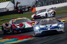 two racing cars driving on a race track