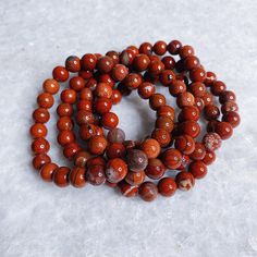 Intuitively Chosen Red Jasper Round Stone Bracelet Includes one bracelet: your choice between approx. a 6mm or 8mm bead. Approx. 7 inch bracelet. Red Jasper Stability | Strength | Vitality | Emotional Endurance Each crystal is intuitively chosen and one of a kind! Due to the natural nature of crystals, each will vary slightly in color and size as sizing is based on weight. **Final Sale Manifesting Freedom, Red Jasper Crystal, Speaking Truth, Red Jasper Bracelet, Releasing Negative Energy, Inner Warrior, Difficult Conversations, Jasper Bracelet, Natural Nature