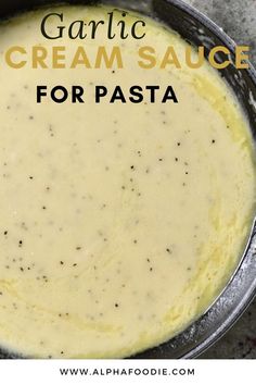 a bowl filled with cream sauce on top of a table