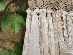 an old lace curtain hanging from a tree