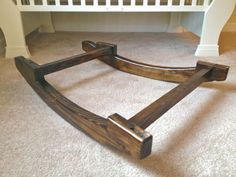 a wooden frame laying on the floor in front of a crib