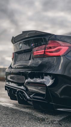 the rear end of a black bmw car