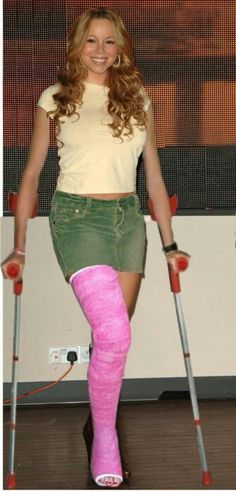 a woman with crutches and pink socks on