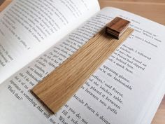 a wooden bookmark laying on top of an open book