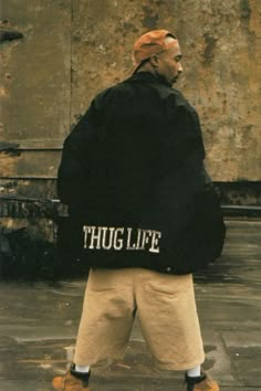 a man is walking down the street with a large bag on his back that says hug life