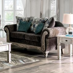 a living room scene with focus on the couch and chair, coffee table and mirror