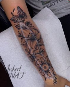 a woman's arm with sunflowers and butterflies on it