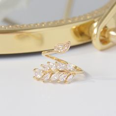 Impress everyone around you with this 14K Gold Plated Floral Leaf Ring with high quality AAA Zirconia. This ring has an adjustable open design to personalize your fit. Our Floral Leaf Ring looks delicate yet sophisticated for any occasion. This classy ring is a must have and will beautify your jewelry box. Gold Floral Leaf Ring Details: Metal 14K Gold Plated with AAA Zirconia Open and adjustable to personalize your fit Hypoallergenic, Tarnish-free Perfect you Parure by pairing our Gold Floral Le Leave Ring, Nature Ring, Daily Jewelry, Floral Jewelry, Leaf Ring, Open Design, Open Ring, Types Of Rings, Ring For Women