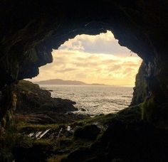 the light at the end of the tunnel is reflecting off the water and clouds in the distance