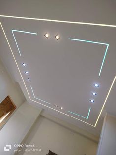 the ceiling in this room is decorated with blue and white lights, along with recessed lighting