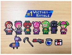 a wooden table topped with lots of pixelated characters and text that reads, victory royale