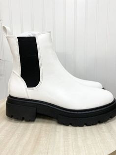 These boots are a chunky pull on boot and are black and white! These are such a cute fashion statement! The material is easy to wipe off and fun to wear everywhere! Trendy White Moto Boots With Round Toe, White Martin Boots With Lug Sole For Fall, White Martin Boots With Platform For Winter, White And Black Boots, Casual White Platform Boots For Winter, Casual White Winter Platform Boots, Trendy Chunky Platform Ankle Boots, Trendy White Round Toe Boots, Trendy White Platform Boots For Fall