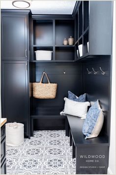 Get inspired by Wildwood Home Co. with this beautiful laundry room design. The use of pattern tile flooring creates a warm and inviting space, while the dark blue cabinets add laundry room storage with a touch of elegance. Explore how you can create a similar look in your own home and make your laundry mud room a stylish and functional space. Visit Wildwood Home Co at wildwoodhomecompany.com to see our full service residential architect and interior design studio and curated shop of homewares.