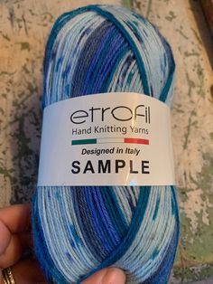 someone is holding a skein of yarn in their left hand and it says, erroll knitting yarns