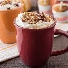 two cups filled with hot chocolate and whipped cream