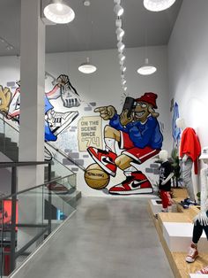 the inside of a sports store with murals on the wall