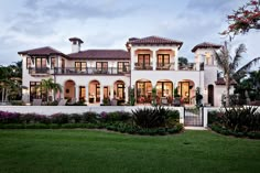 a large white house with lots of windows and balconies on the side of it