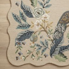 a rug with a bird and flowers on it