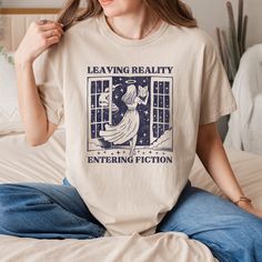 Leaving Reality Entering Fiction T-Shirt, Bookish Shirt, Retro Book Shirt, Book Lover Tee, Bookworm Shirt, Reader, Book Club, Booktrovert  HOW TO ORDER 1-) Please, check and review all photos 2-) Choose your item size and color 3-) Click add to cart. You can go back to add more product 4-)Click "Proceed to check out" 5-)When you check out, you can add a note to seller for any request PRODUCT FEATURE It's a 50% Cotton /50% polyester, 13.5oz fleece. It features a double-needle collar, shoulders, a Book Worm Outfit Aesthetic, Literary Relaxed Fit Crew Neck T-shirt, Literary Cotton Relaxed Fit T-shirt, Literary Style Cotton T-shirt With Relaxed Fit, Relaxed Fit Graphic Print Shirt With Bookish Style, Relaxed Fit Graphic Print Shirt In Bookish Style, Bookish Outfits, Bookish Shirts, Bookish Style