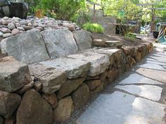 a stone bench sitting next to a pile of rocks