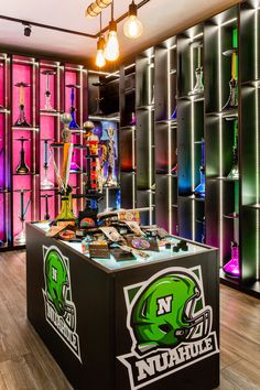 the inside of a sports shop with neon colored shelves and lights hanging from the ceiling