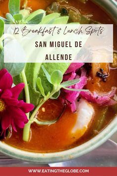 a bowl filled with soup and flowers on top of a table next to the words, 12