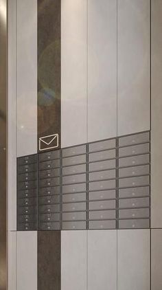 a mailbox is on the wall next to some lockers in an office building