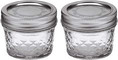 two clear glass jars with metal lids