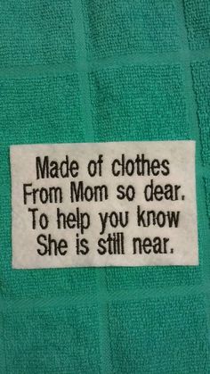 a green towel with a white label that says made of clothes from mom so dear to help you know she is still near