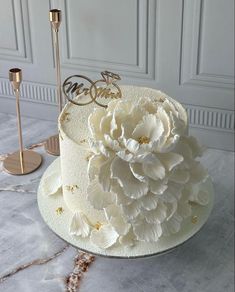 there is a white cake with flowers on it