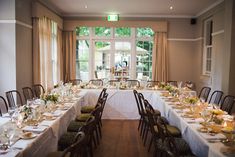 a long dining table set up with place settings