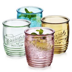 four different colored glasses with mint leaves in them