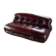 a brown leather couch sitting on top of a white floor