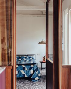 a bed sitting next to a window in a bedroom