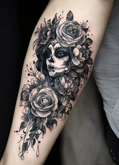 a woman's arm with roses and a skull on it