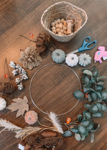 a wooden table topped with lots of different types of crafts and decorations on top of it