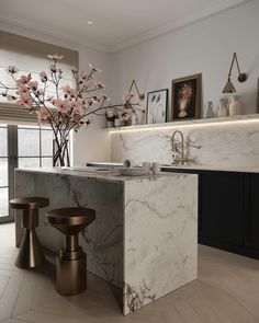 a kitchen with marble counter tops and stools