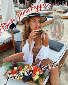 a woman sitting on top of a beach chair eating a slice of watermelon