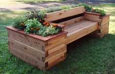 a wooden bench sitting in the grass with plants growing on it's back end