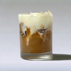 a glass filled with ice cream sitting on top of a table