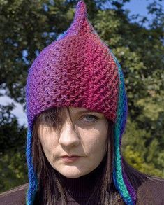 a woman wearing a knitted hat with multicolored yarn