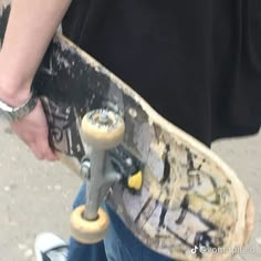 a person holding a skateboard in their hand