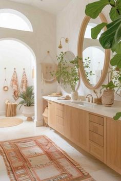 a bathroom with an oval mirror, sink and rug on the floor in front of it