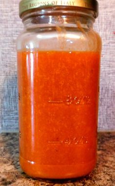 a glass jar filled with liquid sitting on top of a counter