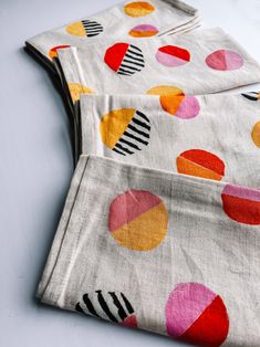 two pieces of cloth with colorful circles on them